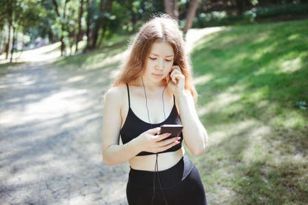 Sporty woman enjoy music in earphones at workoutの写真素材