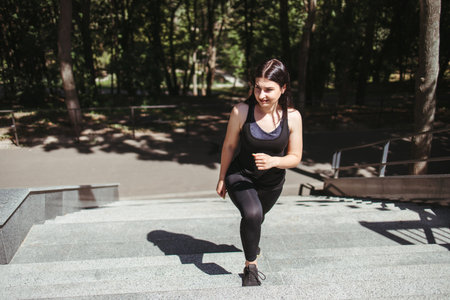 Street fitness.Young woman running on the stairs