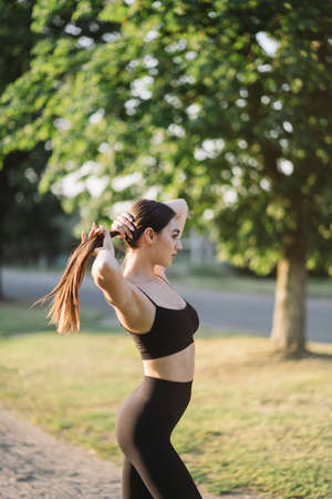 Young woman in activewear exercising outdoorsの写真素材