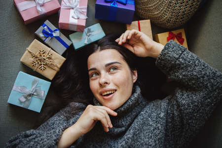 Cute young woman with many present boxesの写真素材