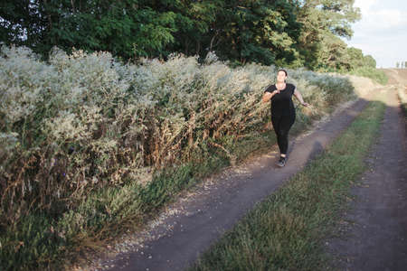 Overweight runner go jogging outdoorsの写真素材