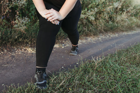 Woman warming up legs before outdoor running
