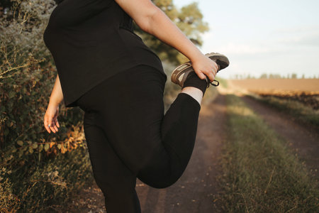 Woman warming up legs before outdoor runningの写真素材