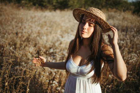 Beautiful woman enjoy walking on summer meadowの写真素材