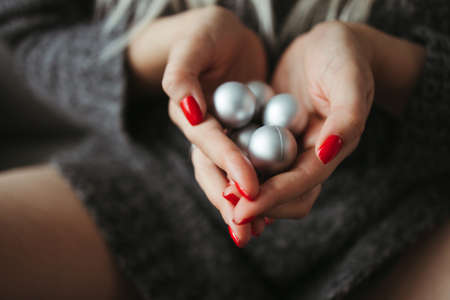 Woman hands holding Christmas baublesの写真素材