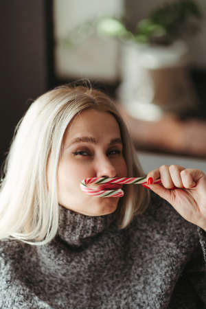 Christmas and New Year holidays, family weekend activities, celebration mood. Woman enjoy sweet treats. Winter warming concept and cozy atmosphereの写真素材