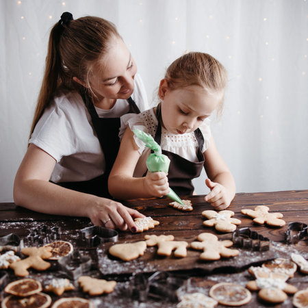 Mother and daughter decorating gingerbread cookies