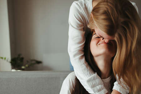 Love, romance, lgbt couple moments. Two young women in love embracing sharing romantic moment together. Happiness, equality, human relationshipsの写真素材