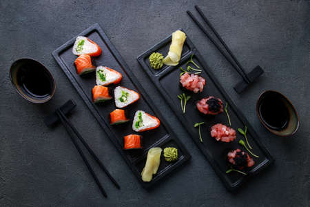 Seafood delicatessen sushi rolls on plates. Different gourmet snacks. Luxury lifestyle, Japanese food art, expensive meals, restaurant menuの写真素材