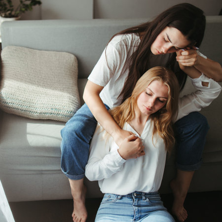 Love, care, human relationships. Lgbt lesbian couple cuddling in living room. Young woman comforting...