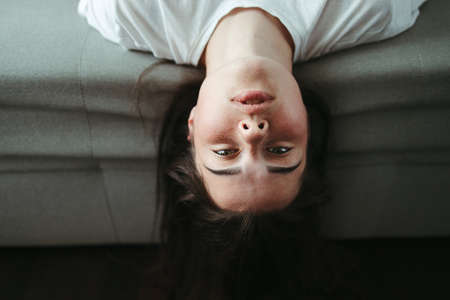 Upside down portrait of young brunette womanの写真素材