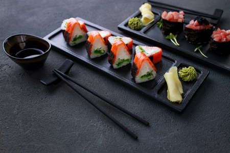 Seafood delicatessen sushi rolls set on platesの写真素材