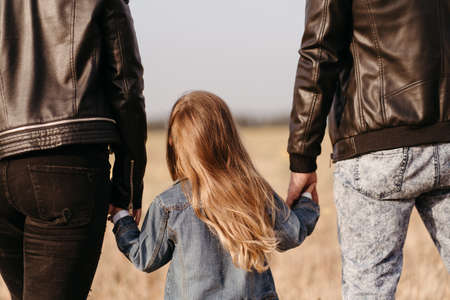 Happy family, bonding and togetherness. Mother, father and daughter walking holding hands. Family timeの写真素材