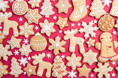 Festive food, kitchen background, texture with homemade gingerbread cookies on red table. Christmas...