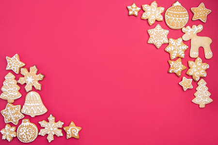 Christmas background with homemade gingerbread cookies on red table, copy space. Festive food, New Year celebration traditionsの写真素材