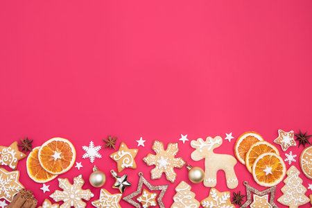 Winter holiday vibes. Frame made of festive decorations, dried oranges, spices and gingerbread on...