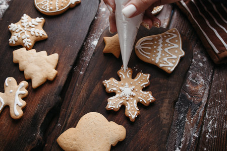 Christmas and New Year celebration. Decorating gingerbread cookies. Holiday activity and family...