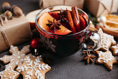 Christmas home atmosphere. Cozy and warming winter drink. Hot mulled wine, delightful festive sweets and gift boxes. Holiday backgroundの写真素材