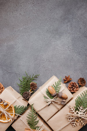Christmas and New Year traditions. Festive decorated gift boxes on gray background, copy space