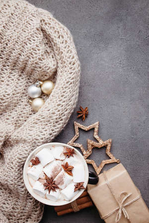 Christmas and New Year traditions concept. Hot chocolate, gift boxes and knitted blanket, top viewの写真素材