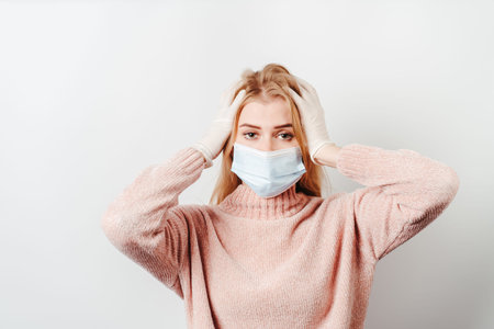 Shocked overwhelmed woman wearing a face maskの写真素材