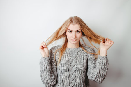 Carefree woman playing with hair. Youth, hair care, lifestyle conceptの写真素材