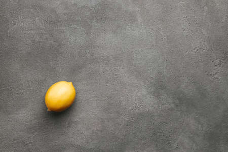 Gray and yellow colors in the color of the year 2021 concept, minimalistic composition with lemon on concrete backgroundの写真素材