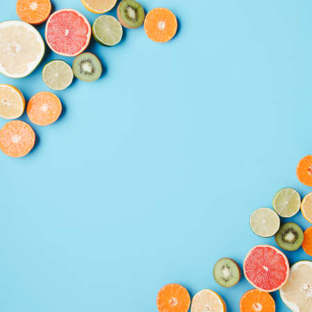 Tropical background, citrus texture on blue background. Summertime vacation, cocktail, tropical beach. Creative fruity layoutの写真素材