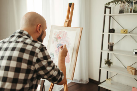 Creative home leisure. Man does easel drawingの写真素材