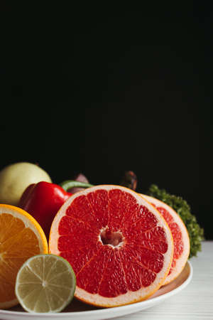 Diet, healthy lifestyle, weight loss, eating habits concept. Plate with fresh appetizing fruits and vegetablesの写真素材