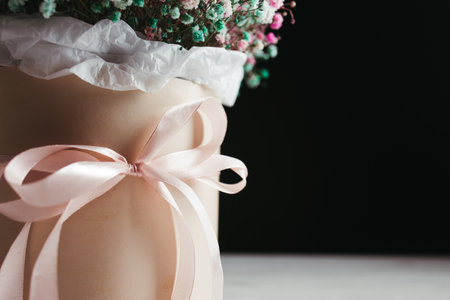 Beautiful bouquet of flowers in a pink gift box. Floral, celebration, birthday, valentine concept. Copy spaceの写真素材