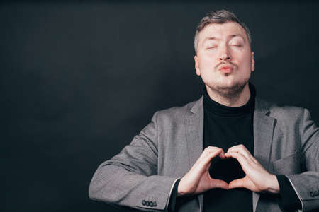 Happy man making heart gestureの写真素材