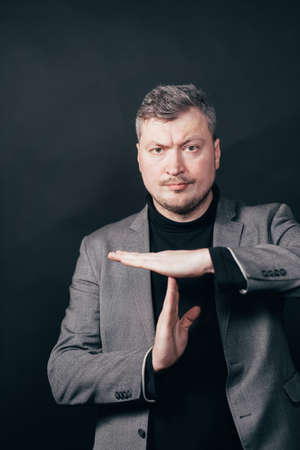 Confident man showing T sign with handsの写真素材