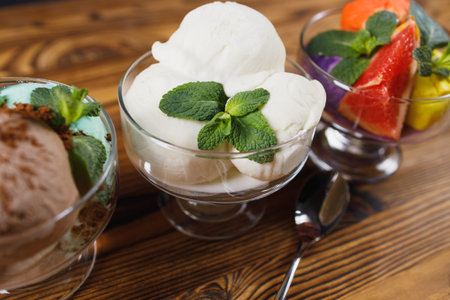 Set of ice cream scoops in glass sundae bowls