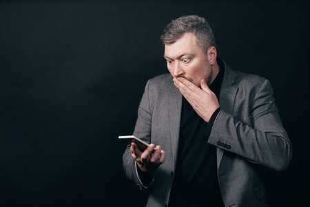 Frustrated scared man with smart phone