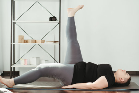 Overweight woman doing physical exercises at home