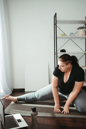 Overweight woman doing stretching exercise
