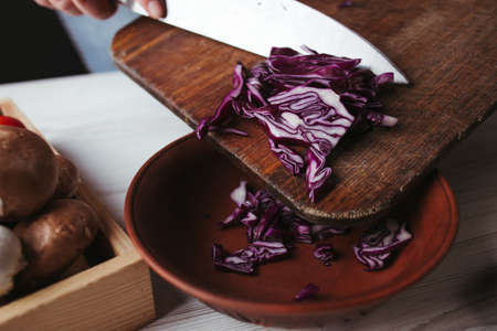 Woman preparing healthy vegetarian food in kitchenの写真素材