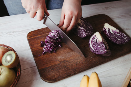 Female hands making healthy fresh vegetable salad