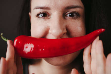 Young woman having fun with fresh vegetablesの写真素材