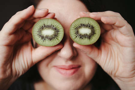 Young woman having fun with fresh fruitsの写真素材
