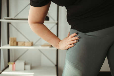 Young overweight woman doing home sport exercisesの写真素材