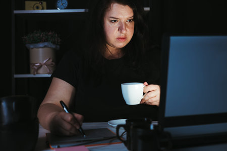 Designer drawing at graphic tablet late at night