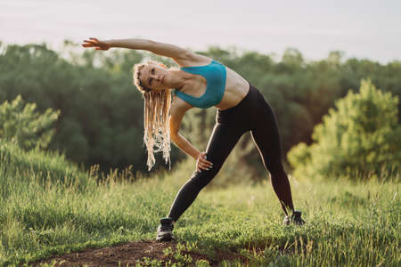 Sporty fit woman doing morning workout outdoorsの写真素材