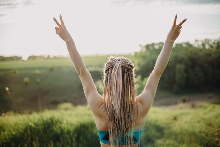 Sporty fit woman raising arms express positivity