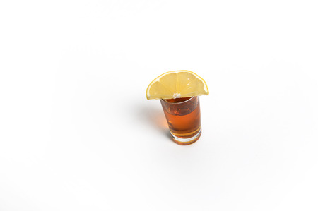Glass of brandy and ââlemonの写真素材
