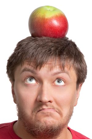 Funny young student with an apple on his headの写真素材