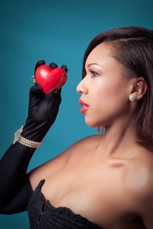 Beautiful young woman holding a heartの写真素材