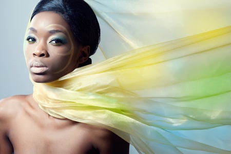 Beautiful fashion model with a silk scarf, flying on the windの写真素材