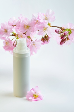 Daily skin care concept  face cream with sakura flowersの写真素材